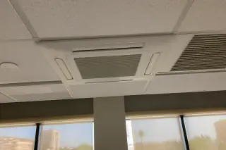 Ceiling-cassette VRF unit flush-mounted in a drop ceiling grid in a Phoenix, AZ office.