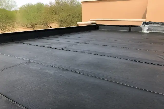 Built-up roofing layers with asphalt seams on a commercial building in Mesa, AZ.
