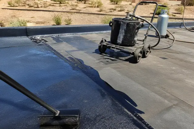 Built-up roofing installation showing bitumen layers and asphalt application at a jobsite in Chandler, AZ.