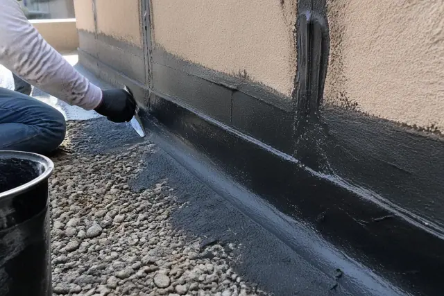 Cold-applied membrane flashing on a parapet wall at a roofing jobsite in Phoenix, AZ.