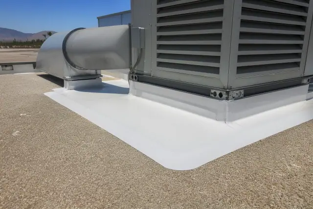 Heat-welded membrane patch on a flat roof around a ventilation unit in Peoria, AZ.