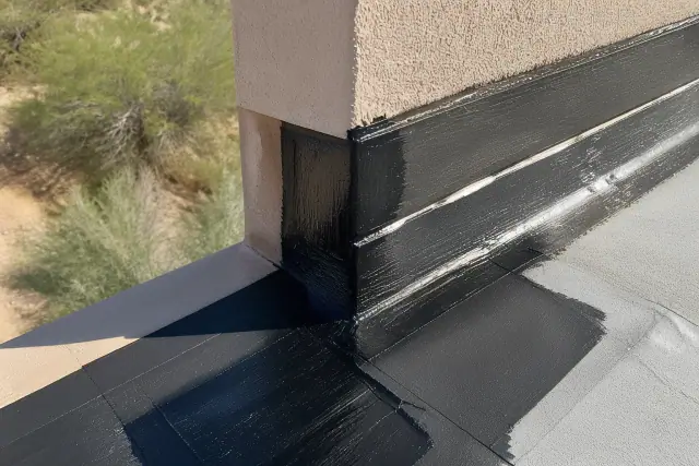 Flat roof membrane repair on a stucco parapet wall in Glendale, AZ with visible heat-applied sealant.