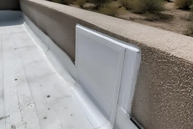 Flat roof membrane repair with sealed parapet wall flashing at a job site in Chandler, AZ.