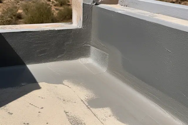 Elastomeric coating applied to a roof parapet wall during a commercial roof repair in Phoenix, AZ.