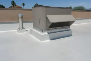 Sealed roof membrane and curb flashing around a ventilation unit on a commercial building in Phoenix, AZ.