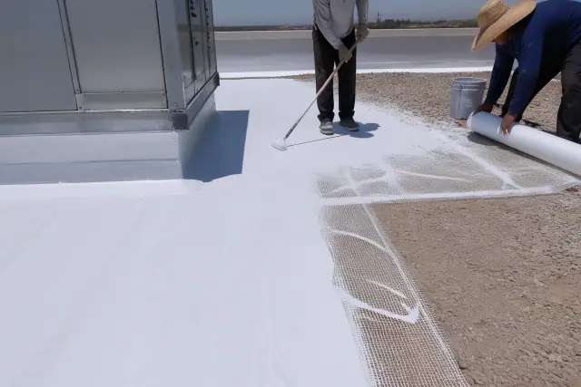 Reflective white roof coating application on a commercial building in Chandler, AZ.