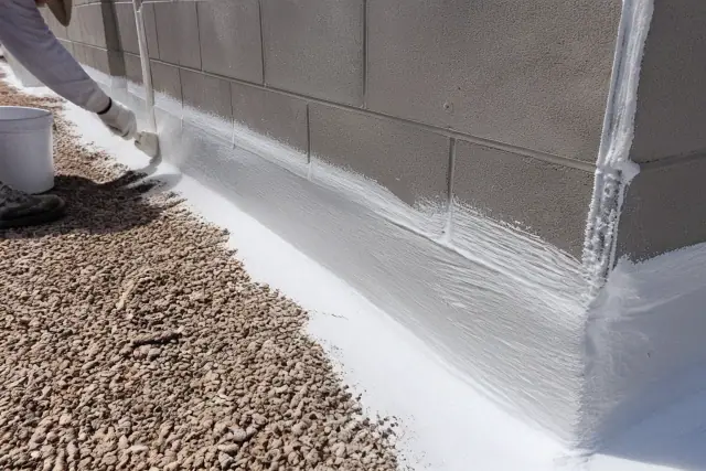 Close-up of a thick elastomeric coating applied to a parapet wall on a commercial roof in Mesa, AZ.
