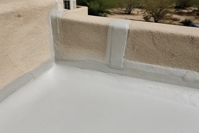 Liquid-applied roof coating applied to a parapet wall flashing at a commercial building in Glendale, AZ.