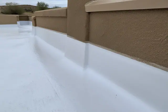 Elastomeric liquid membrane coating applied to a parapet wall flashing at a commercial roofing site in Tempe, AZ.