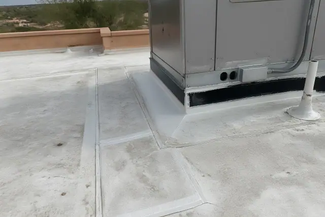 A technician inspects a reinforced roof membrane seam near a ventilation unit on a commercial building in Peoria, AZ.