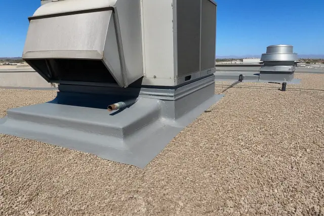 Grey elastomeric roof coating around a ventilation unit on a gravel roof in Mesa, AZ.