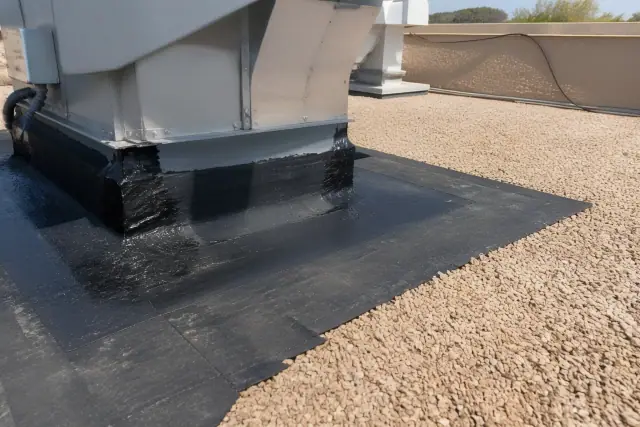 Roof membrane sealant work around a ventilation unit on a gravel rooftop in Chandler, AZ.