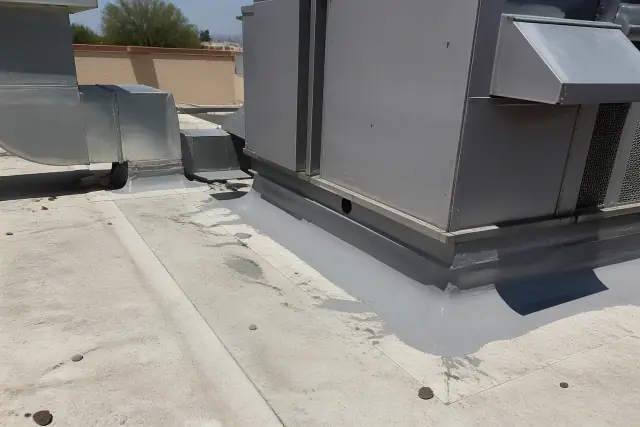 Roof technicians applying grey sealant to a rooftop HVAC unit at a commercial building in Surprise, AZ.