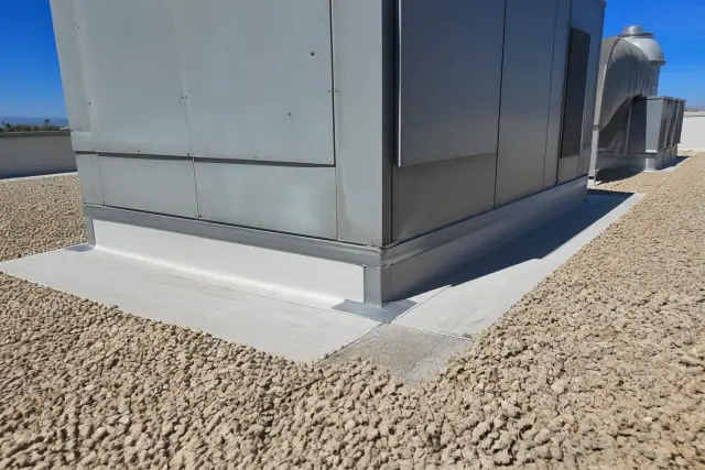 Roof membrane detailing and sealant around an HVAC unit on a commercial rooftop in Tempe, AZ.