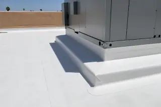 Sealed membrane flashing around a large rooftop HVAC unit near a stucco parapet in Phoenix, AZ.