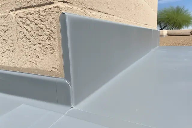 Gray TPO membrane roof installation with heat-welded seams on a parapet wall in Surprise, AZ.