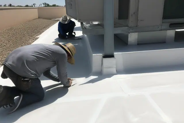 Technicians performing TPO membrane roof replacement around an HVAC unit in Tempe, AZ.