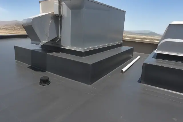 Technicians installing TPO roofing membrane around a rooftop ventilation unit in Goodyear, AZ.