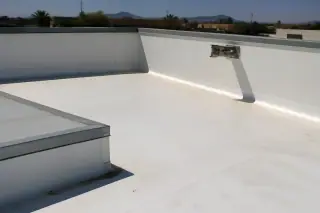 White membrane roof with sealed parapet corners and galvanized hardware in Phoenix, AZ.