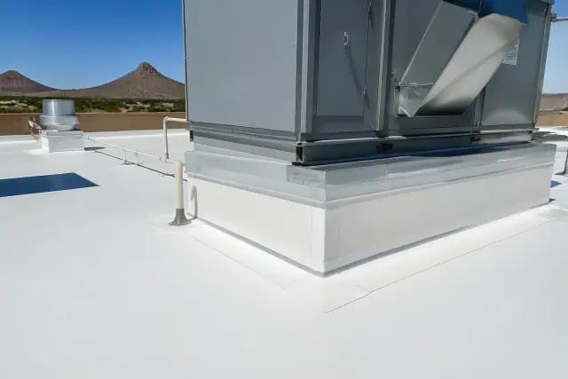 White TPO roofing membrane installation around a ventilation unit on a commercial building in Phoenix, AZ.