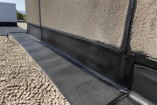 Modified bitumen roofing showing heat-welded seams at a parapet wall in Phoenix, AZ.