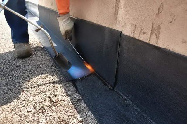 Open torch-applied membrane seal at a roof parapet wall seam in Phoenix, AZ.
