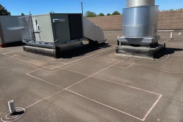 Chalk layout for membrane detailing around a rooftop ventilation unit on a gravel-ballasted roof in Phoenix, AZ.