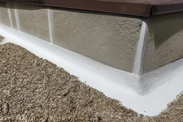 White reflective roof coating applied to a parapet wall flashing on a modified bitumen roof in Phoenix, AZ.