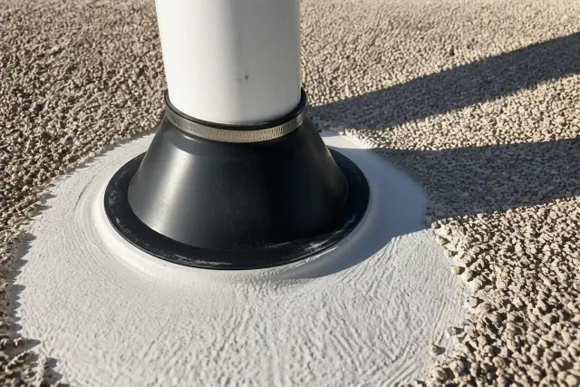 Spray foam roofing repair around a vent pipe on a gravel roof in Phoenix, AZ.