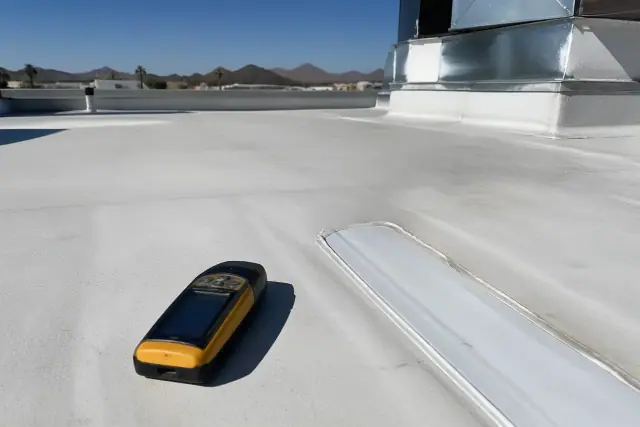 A moisture scan tool on a membrane roof during a commercial inspection in Phoenix, AZ.