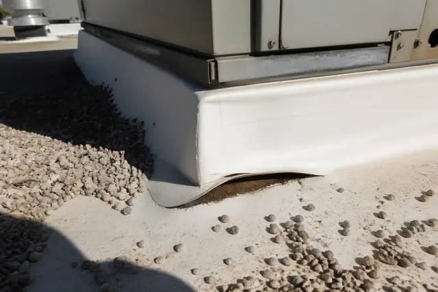 Separated TPO seam at an HVAC curb on a flat gravel roof in Phoenix, AZ.
