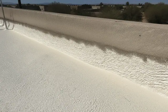 Spray foam roof insulation applied to a parapet wall during a commercial inspection in Phoenix, AZ.