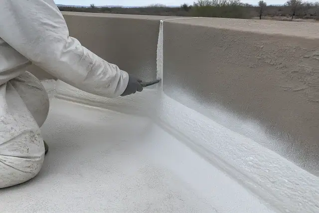 Spray foam roofing applied to a parapet wall at a commercial job site in Mesa, AZ.