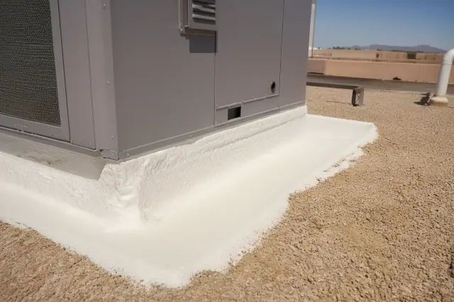 Spray foam roofing applied around a rooftop ventilation unit on a commercial building in Chandler, AZ.
