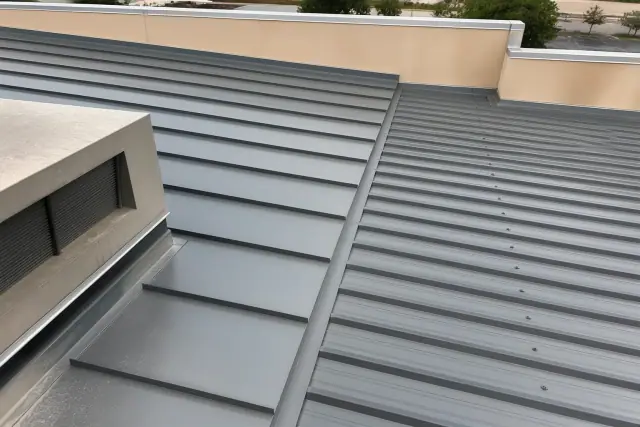 Completed standing-seam and R-panel metal roofing on a commercial building in Phoenix, AZ.