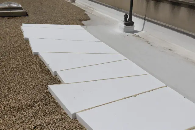 Tapered insulation boards installed on a flat roof with gravel ballast in Phoenix, AZ.