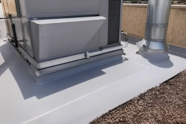 Hot-air welded TPO membrane repair on a commercial flat roof near a ventilation unit in Phoenix, AZ.