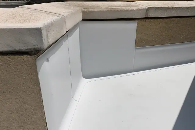 Heat-welded TPO membrane seams on a commercial flat roof parapet wall in Phoenix, AZ.