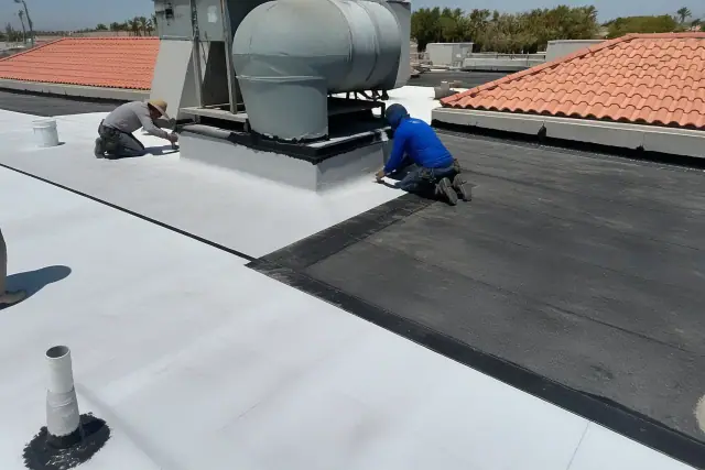 Technicians installing TPO and bitumen roofing around a rooftop unit in Phoenix, AZ.