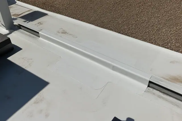 Heat-welded TPO roof repair patch on a substrate transition in Phoenix, AZ.