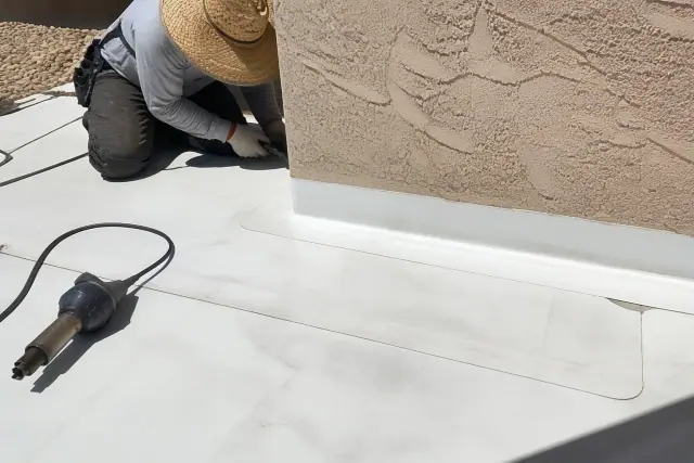 White TPO roofing membrane with heat-welded seams on a commercial flat roof in Glendale, AZ.