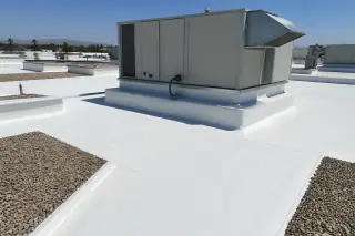 TPO membrane roofing installed around a rooftop HVAC unit with desert gravel ballast in Phoenix, AZ.