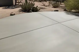 Smooth concrete slab surface with prickly pear cacti and desert landscaping in Phoenix, AZ.