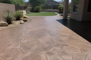 Finished stamped concrete patio with stone texture and desert landscaping in Phoenix, AZ.