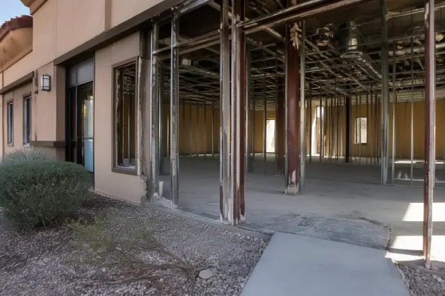 Commercial office demolition showing exposed structural studs and utility conduits at a jobsite in Chandler, AZ.