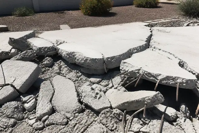 Fractured concrete slab with exposed rebar at a structural demolition jobsite in Phoenix, AZ.