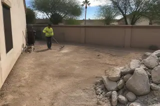Fractured concrete slab with exposed rusted rebar on a residential jobsite in Phoenix, AZ.