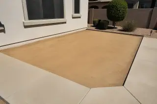 Flat graded dirt base where a concrete slab was removed from a residential lot in Phoenix, AZ.