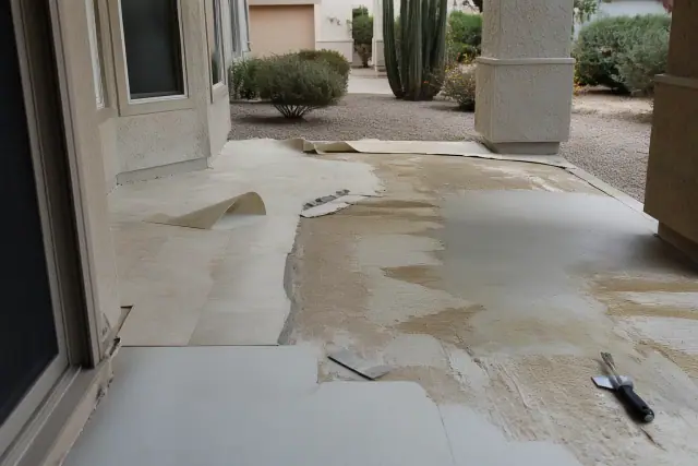 Vinyl floor removal on a subfloor with exposed adhesive at a residential jobsite in Surprise, AZ.