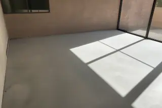 Cleaned concrete subfloor with natural sunlight shadows in a residential home in Phoenix, AZ.